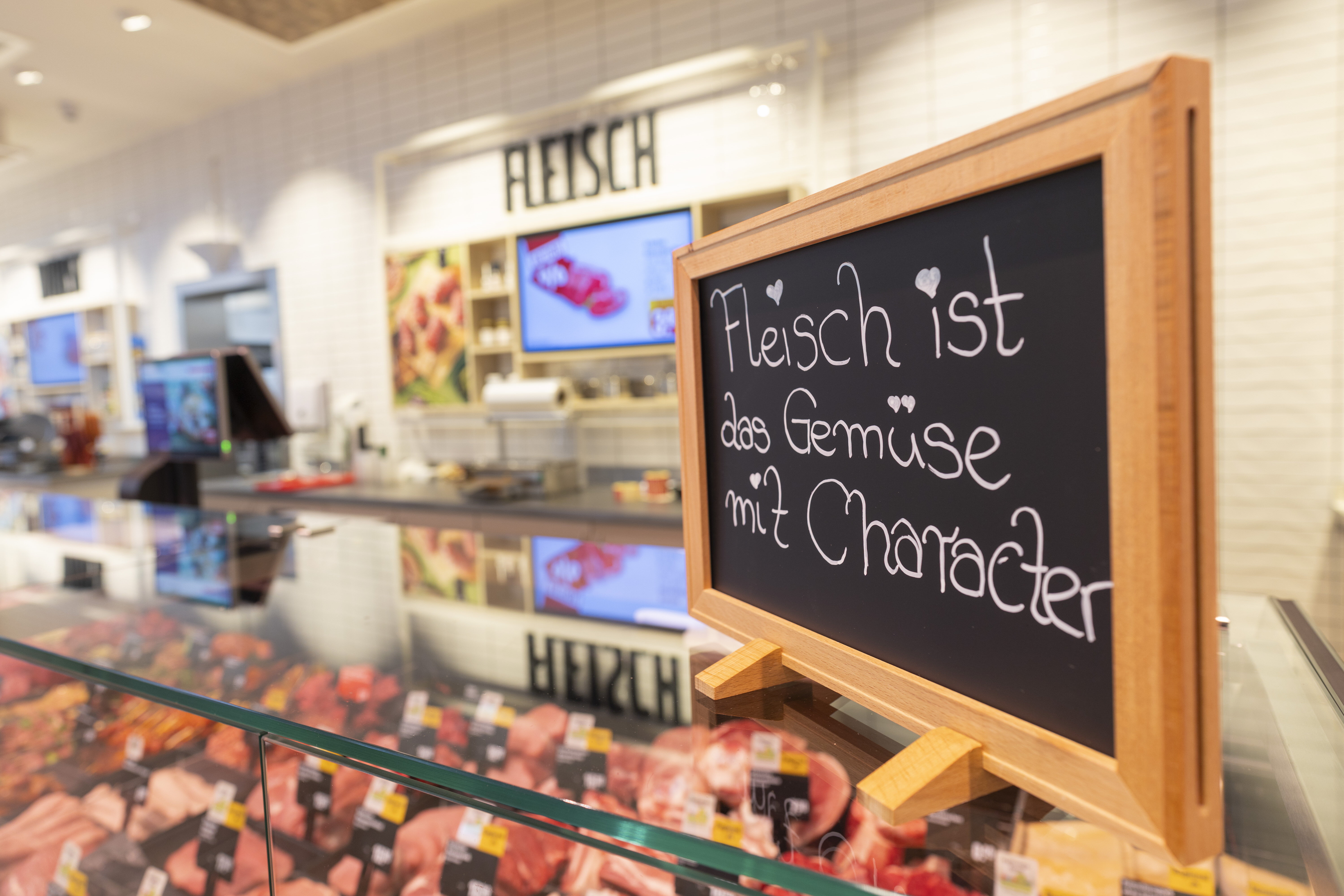 Schild auf der Fleischtheke mit Aufschrift "Fleisch ist Gemüse mit Charakter"